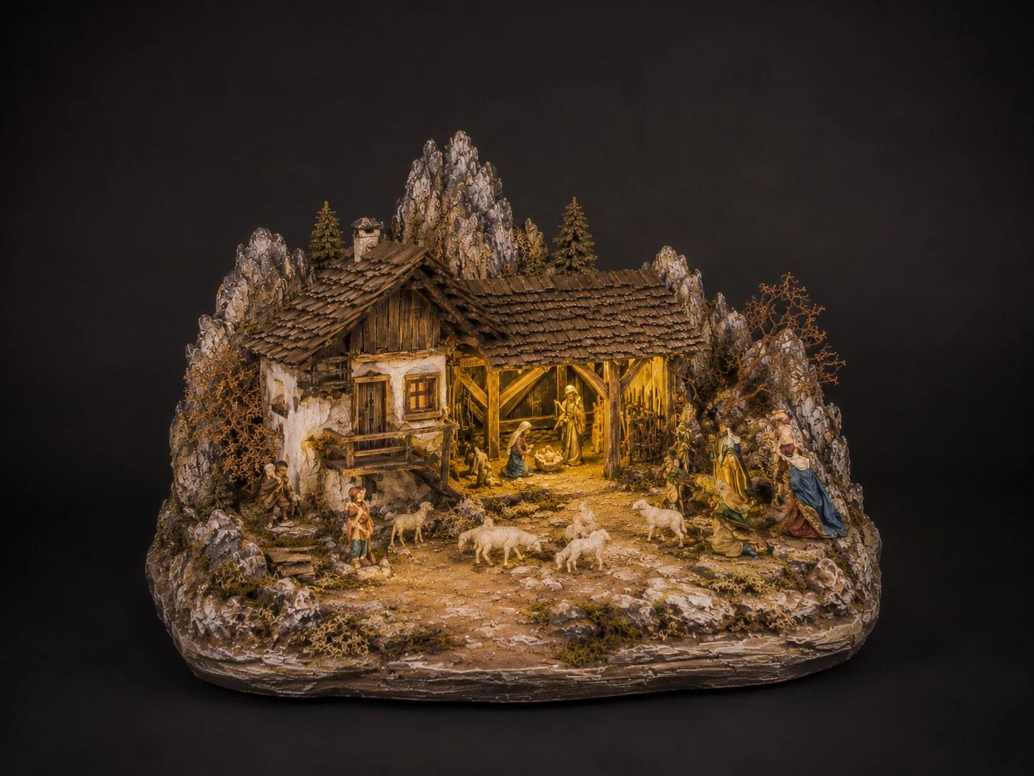 Alpina Piccola handcrafted alpine nativity scene with mountain farmhouse, rocks, and warm lighting